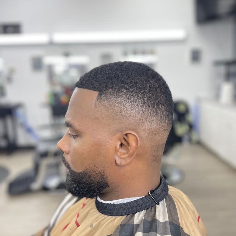 Precision fade haircut with clean lines and perfect blending - Professional barbering work by Isaiah Barber